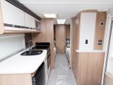 A TV point and sockets are on the right as you enter the Coachman VIP 565, above a slender shelf