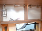 The kitchen's overhead lockers aren't shelved, but have some useful racking to keep items secure