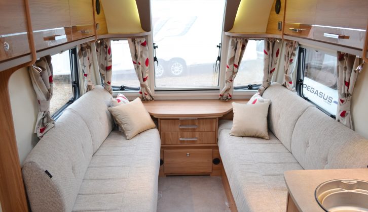 The large window sweeps up the front of the van, letting light flood in, pale fabrics increasing the sense of space