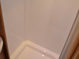 There may be just one drain hole, but the shower is big, and has a rooflight and shelves