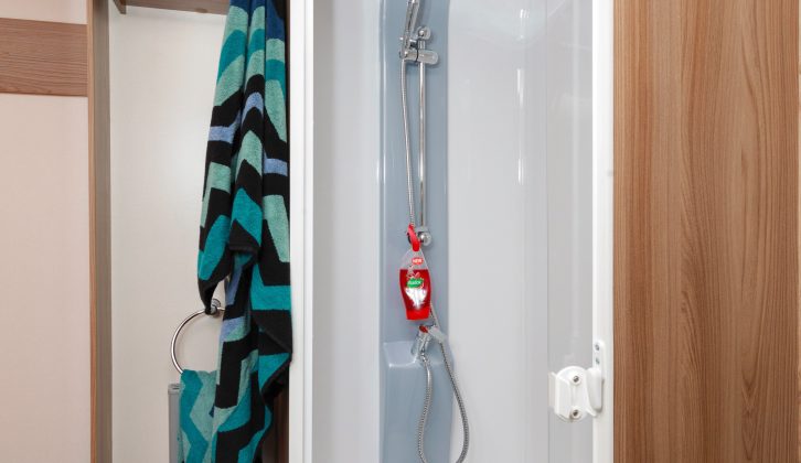 The towel rail is within easy reach of the circular shower cubicle, just above the radiator
