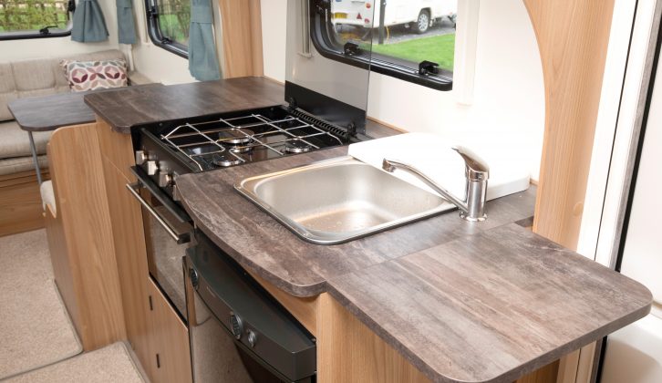 With the worktop flap up, there’s plenty of space for food preparation, while the three-burner hob and combined oven and grill are joined by a standard-fit microwave