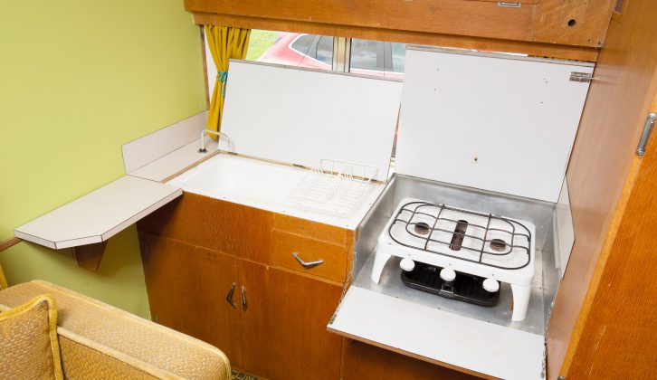 The sink and stove are concealed beneath counter top