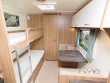 The side dinette opposite the bunks provides an extra space for children and can convert into a single bed that should take one child well into their teenage years