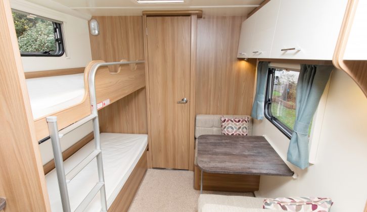 The side dinette opposite the bunks provides an extra space for children and can convert into a single bed that should take one child well into their teenage years