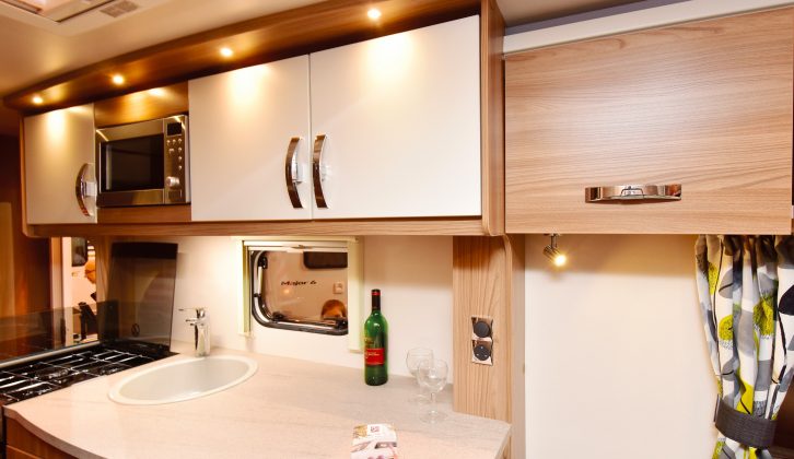The kitchen includes plenty of deep workspace, a 100-litre Dometic fridge, an oven and, with the Diamond Pack, a microwave above the sink – plus good LED lighting