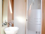 The fully lined corner shower unit suffers some intrusion from the wheelarch, however we like the stylish basin