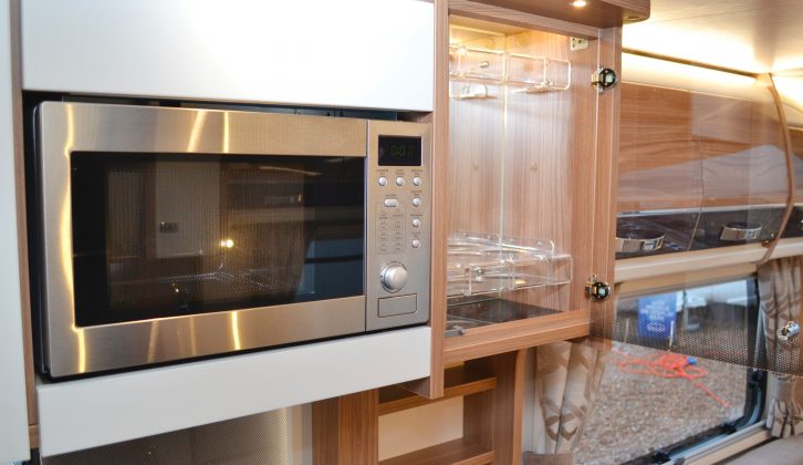 A microwave and cocktail cabinet are nice additions in this Swift caravan