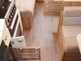 Pull-out wire racking on both sides of the aisle means you can make the most of the storage space in this caravan