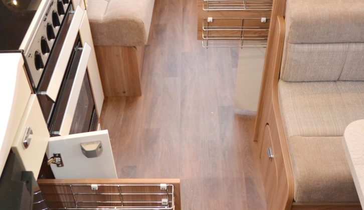 Pull-out wire racking on both sides of the aisle means you can make the most of the storage space in this caravan