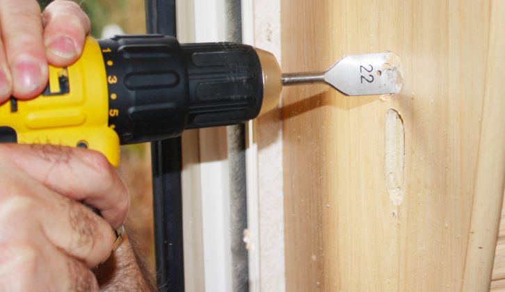 Open up the hole as necessary –
 we used a 22mm wood bit, but your situation may differ