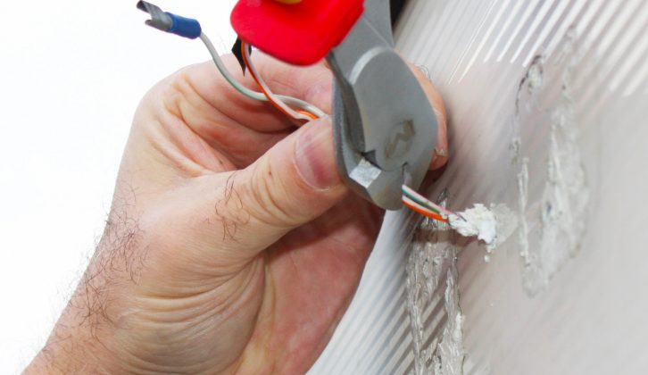Cut and insulate the old wires using a wire-stripper, before tucking into the wall