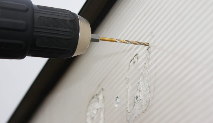 Check the wiring location on the new unit, then drill a pilot hole and then an 8mm hole