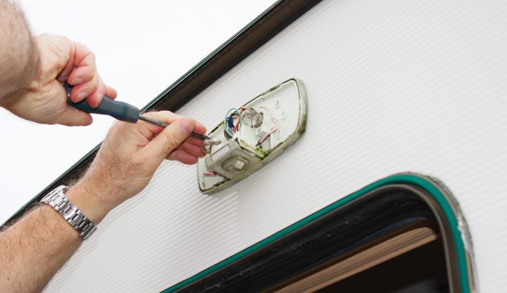 First, remove the old light cover and take out the screws securing the unit to the caravan