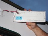Add sealant to the back of the new light unit before fixing it to the caravan with screws