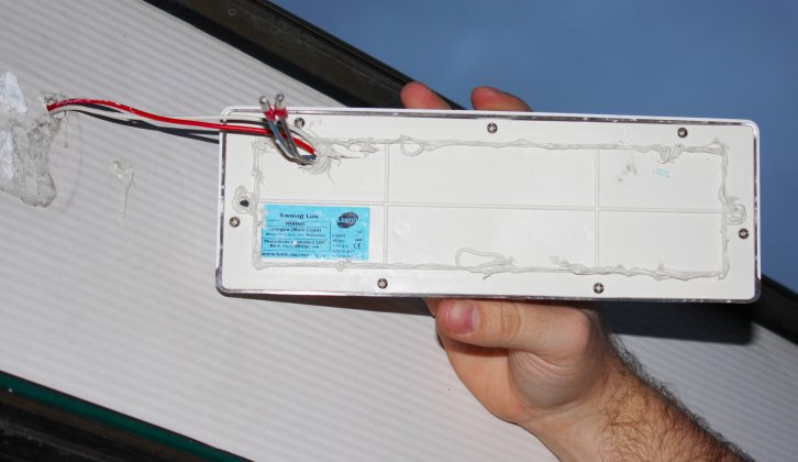 Add sealant to the back of the new light unit before fixing it to the caravan with screws