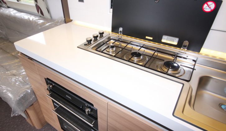 The cover lifts up to expose the Thetford in-line three-burner hob, which is also surrounded by a handy amount of worktop