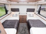 The rear fixed single beds measure 0.69m x 1.84m – and as well as each getting a big window, there's a good-sized centre chest here, too