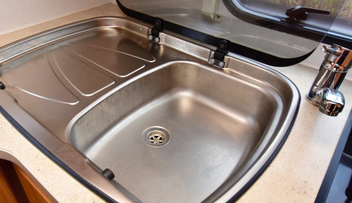 The stainless-steel sink with integrated drainer also features a glass top that can be used as extra work surface