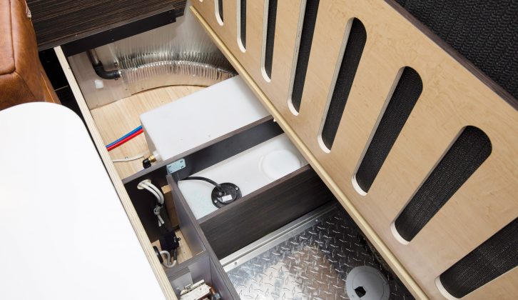 The underseat storage in the lounge of this Airstream caravan loses out to the central heating boiler and water tank