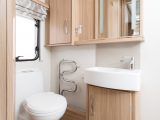 Access the end washroom via a domestic-style door and you'll find a heated towel rail, a good-sized basin and ample storage in the Coachman Pastiche 565
