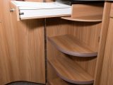 The neat, curved door opens to reveal a trio of shelves and a cutlery drawer