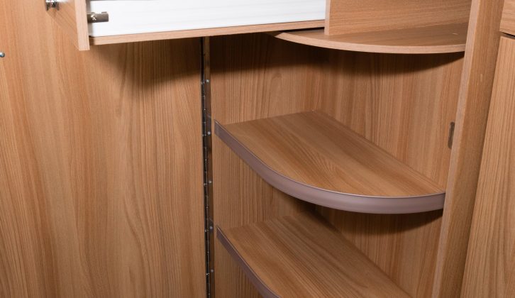 The neat, curved door opens to reveal a trio of shelves and a cutlery drawer