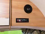 Speakers and shelves sit in the front corners of the lounge, with a CD/MP3 player/radio on the nearside