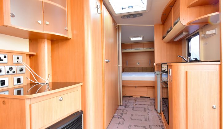 This line-up of Adria caravans uses a light wood finish to keep the interior feeling spacious, and there is a Heki over the kitchen