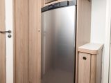 The microwave sits high, above the fridge/freezer – the freestanding lounge table stows in its dedicated storage cupboard to the right