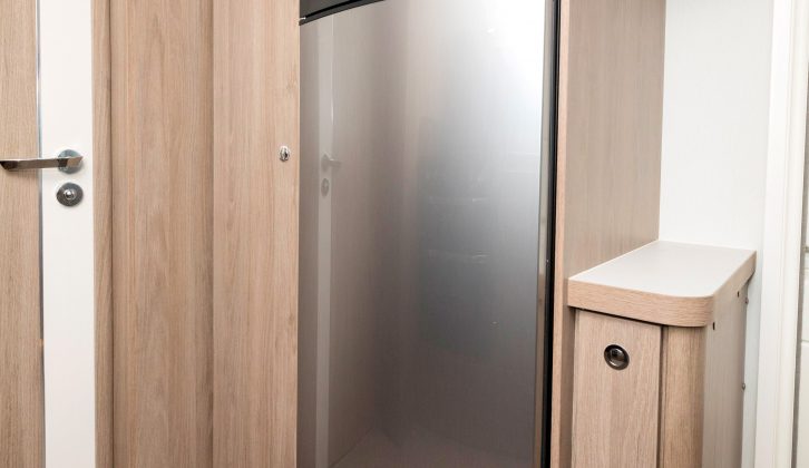 The microwave sits high, above the fridge/freezer – the freestanding lounge table stows in its dedicated storage cupboard to the right