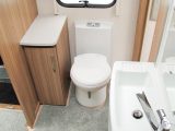 The washroom has a Belfast sink at its centre, as well as three cupboards, a heated towel rail and a nearside circular shower