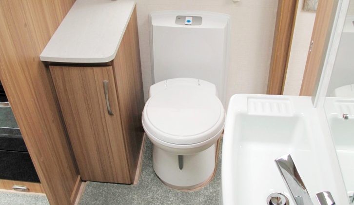 The washroom has a Belfast sink at its centre, as well as three cupboards, a heated towel rail and a nearside circular shower