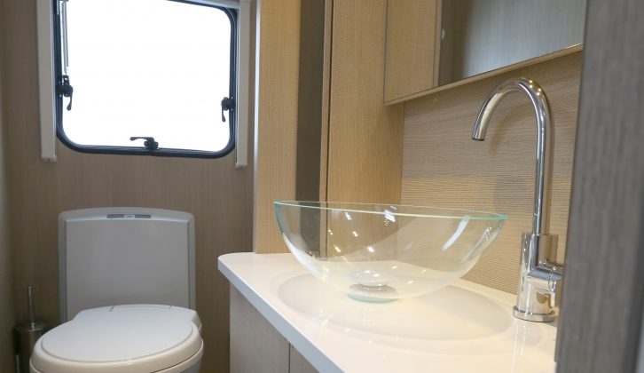 There's a chic salad-bowl sink and chrome tap in the end washroom of this Adria caravan