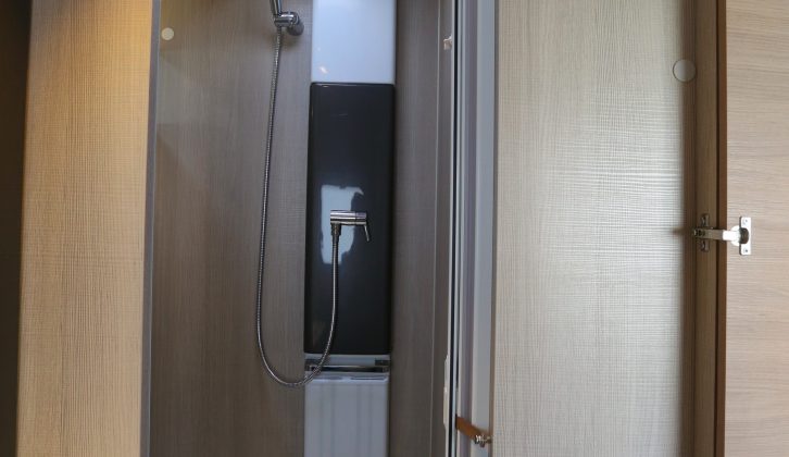 The washroom has a domestic-style door and a shower cubicle with a smart riser