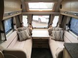 The large central window, sunroof and stargazer rooflight provide plenty of daylight in the lounge of this Elddis caravan