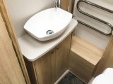 The offside part of the washroom has a rooflight, an Alde radiator and a salad-bowl sink