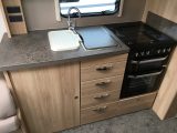 There's a granite-effect worktop, two mains sockets, a separate oven and grill, and a microwave in the offside kitchen
