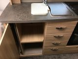 Four drawers under the sink and this shelved cupboard are just part of the generous kitchen storage space