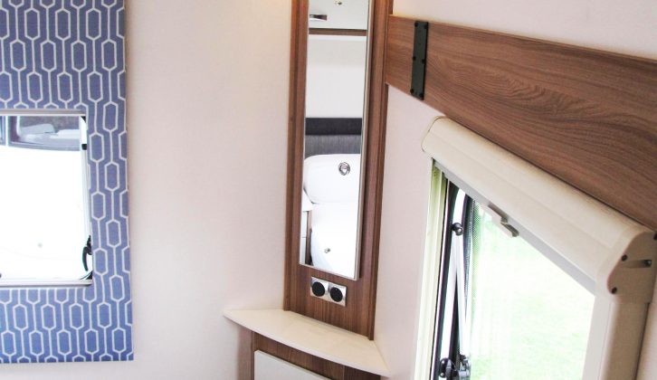 This dresser unit has been well executed, with two cupboards, a mirror, sockets and spotlights