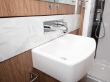 The handbasin's concealed tap is a very smart feature in this caravan's end washroom