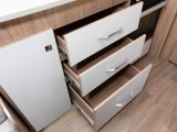 Next to this is a trio of white-fronted drawers with smart handles
