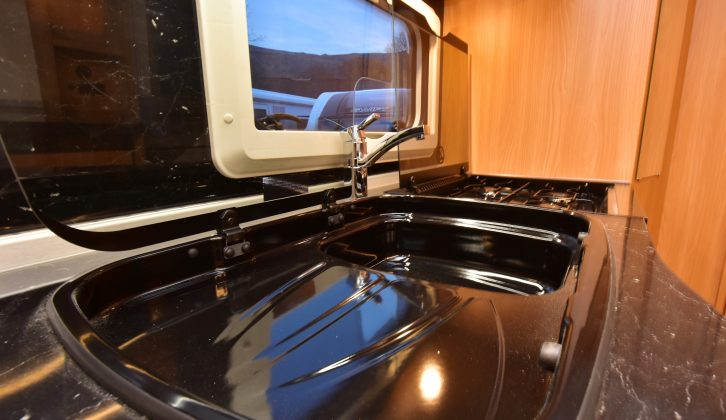 The sink has a built-in drainer – some might find the worktop too dark and dated