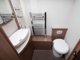 Moving into the central washroom, the toilet and sink are on the offside – we like the concealed cistern and the heated towel rail