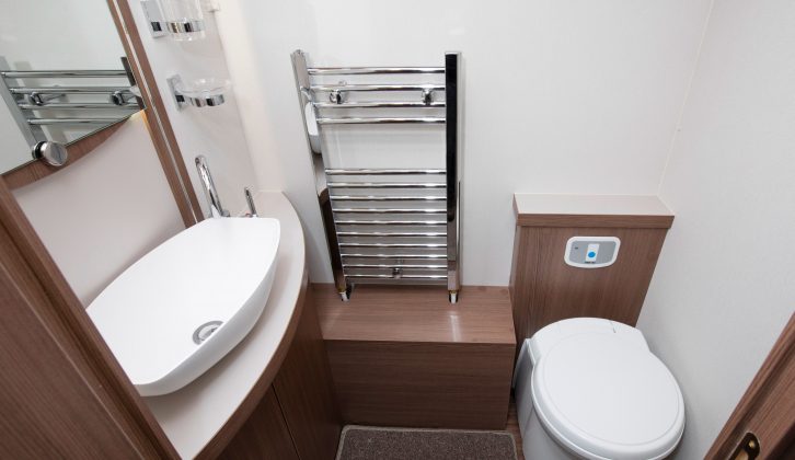 Moving into the central washroom, the toilet and sink are on the offside – we like the concealed cistern and the heated towel rail