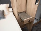 Storage units flank the bed and we like these pull-out shelves in lieu of bedside tables