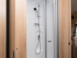 Opposite, behind a bi-fold door, is this shower cubicle which is a good size, despite the wheel arch intrusion