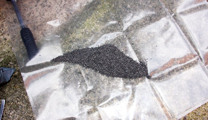 Excess grit drops onto the plastic sheet and can be gathered up to be used again