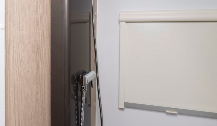 The panel for the shower controls is the only non-white feature in the washroom – even the blind is white!