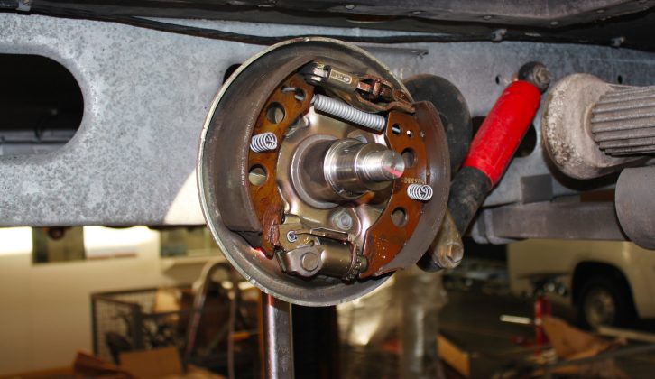 The caravan's brake drum is removed revealing the old mechanism